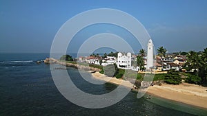 Aerial view of Galle Fort, coastline and historic architecture in Sri Lanka. Ocean waves crash against rocks, white