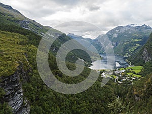 Aerial view on Geirangerfjord fjord with Geiranger tourist village and cruise ship, UNESCO World Heritage. View from