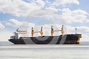 Aerial view of general cargo ship in open sea.