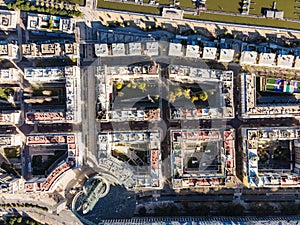 Aerial view of geometric architecture district with the old refinery oil tower in disuse along Tagus river in Lisbon, Portugal