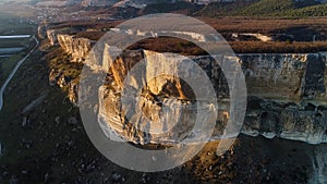 Aerial view of a giant beautiful cliff under sunset light. Shot. Natural landscape of a breathtaking rock with flat top