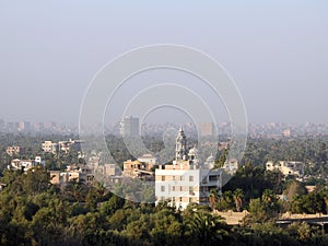 Aerial view of Giza Egypt with fields at the country side and modern buildings and crowded houses