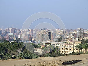 Aerial view of Giza Egypt with fields at the country side and modern buildings and crowded houses