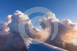 Aerial view of golden clouds lit by the evening sun over Florida, view from the aircraft during the flight.