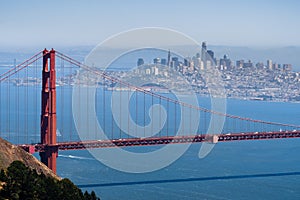 Aerial view of Golden Gate Bridge; the San Francisco skyline visible in the background; California