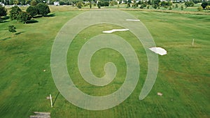 Aerial View of a Golf Course, Aerial perspective of a golf course with green fairways and sand traps.