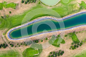 Aerial view of golf course. Drone or helicopter view of green field sand bunker and water hazard