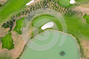 Aerial view of golf course. Drone or helicopter view of green field sand bunker and water hazard