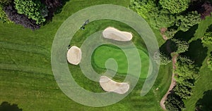 Aerial view of Golf course. Establishing shot, drone flying over golf club