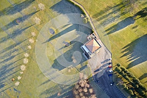 Aerial view of golf course green and clubhouse from above frozen grass in winter at Aboyne Aberdeenshire Scotland