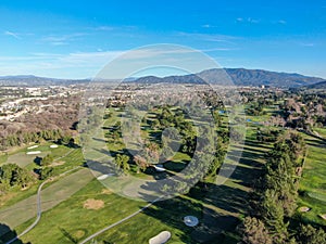 Aerial view of golf course with green field in the valley.