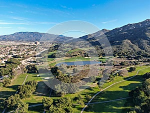 Aerial view of golf course with green field in the valley.