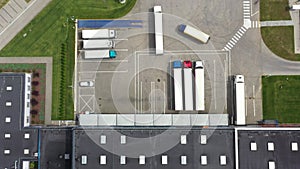 Aerial view. goods distribution warehouse. Semi trucks loading cargo containers. Logistics export and import cargo distribution