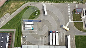 Aerial view. goods distribution warehouse. Semi trucks loading cargo containers. Logistics export and import cargo distribution