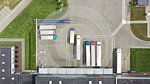 Aerial view. goods distribution warehouse. Semi trucks loading cargo containers. Logistics export and import cargo distribution