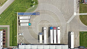 Aerial view. goods distribution warehouse. Semi trucks loading cargo containers. Logistics export and import cargo distribution