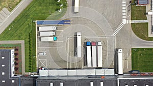 Aerial view. goods distribution warehouse. Semi trucks loading cargo containers. Logistics export and import cargo distribution