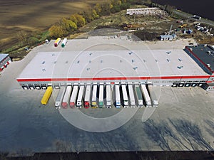 Aerial view of goods warehouse. Logistics center in industrial city zone from above.