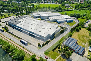 Aerial view of goods warehouse. Logistics center in industrial city zone from above. Aerial view of trucks loading at logistic photo