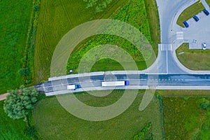 Aerial view of goods warehouse. Logistics center in industrial city zone from above. Aerial view of trucks loading at logistic