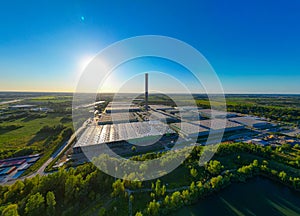 Aerial view of goods warehouse. Logistics center in industrial city zone from above. Aerial view of trucks loading at logistic