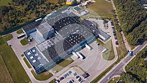 Aerial view of goods warehouse. Logistics center in industrial city zone from above. Aerial view of trucks loading at logistic cen