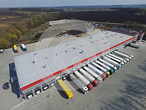 Aerial view of goods warehouse. Logistics center in industrial city zone from above. photo