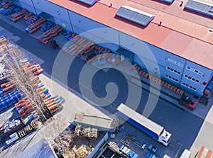 Aerial view of goods warehouse. Logistics center in industrial city zone from drone view. Background texture concept