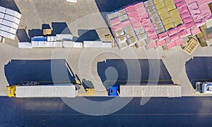 Aerial view of goods warehouse. Logistics center in industrial city zone from drone view. Background texture concept