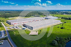 Aerial view of goods warehouse. Logistics center in industrial city zone from drone view. Background texture concept