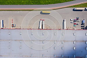 Aerial view of goods warehouse. Logistics center in industrial city zone from drone view. Background texture concept