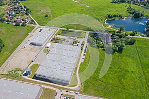 Aerial view of goods warehouse. Logistics center in industrial city zone from drone view. Background texture concept