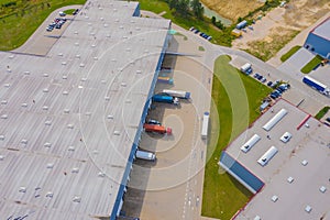 Aerial view of goods warehouse. Logistics center in industrial city zone from drone view. Background texture concept