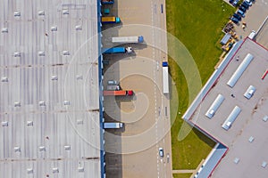 Aerial view of goods warehouse. Logistics center in industrial city zone from drone view. Background texture concept