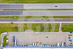 Aerial view of goods warehouse. Logistics center in industrial city zone from drone view. Background texture concept