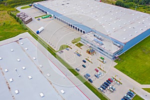 Aerial view of goods warehouse. Logistics center in industrial city zone from drone view. Background texture concept