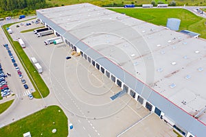 Aerial view of goods warehouse. Logistics center in industrial city zone from drone view. Background texture concept