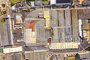 Aerial view of goods warehouse. Logistics delivery center in industrial city zone from above. Aerial view of trucks loading at