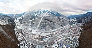 Aerial view of Gorki Gorod Ski Resort, mountains covered by snow in Krasnaya Polyana, Russia.