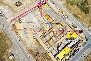 Aerial view from a greater height above the cranes of a construction site with the carcasses for new apartments in a growing Germa