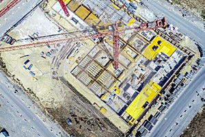 Aerial view from a greater height above the cranes of a construction site with the carcasses for new apartments in a growing Germa