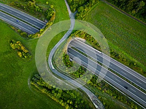 Aerial view of a green bridge ecoduct for fauna crossing above the highway