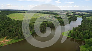 Aerial view of green forest and winding river valley in summer, Russia. River water landscape with forest around.