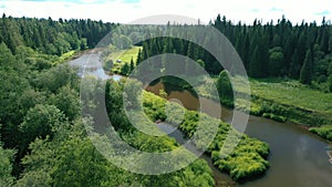 Aerial view of green forest and winding river valley in summer, Russia. River water landscape with forest around.