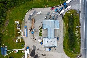 Aerial view of green gas station in the city near the road for cars. The concept of increasing the cost of gasoline and