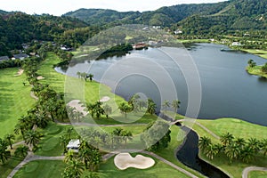 Aerial view of the green golf course in Thailand Beautiful green grass and trees on a golf field with fairway and putting green in