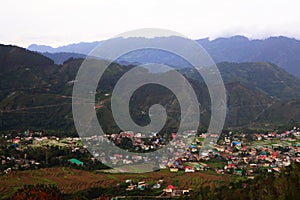 Aerial view of green hills of village in himachal surrounded by forest and countryside.