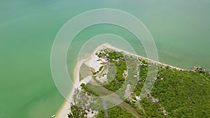 Aerial view green island and sea. Beautiful view from flying drone over tropical island and sandy sea shore. Landscape