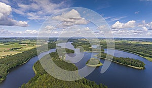 Aerial view of green islands and clouds at summer sunny day.Wydminy lake on Masuria in Poland.