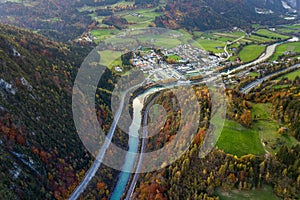 Aerial view of green meadows with villages and forest in austrian Alps mountains